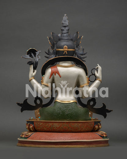 Back view of Chenrezig statue featuring crown knot, deer skin drape, and hand-carved lotus base