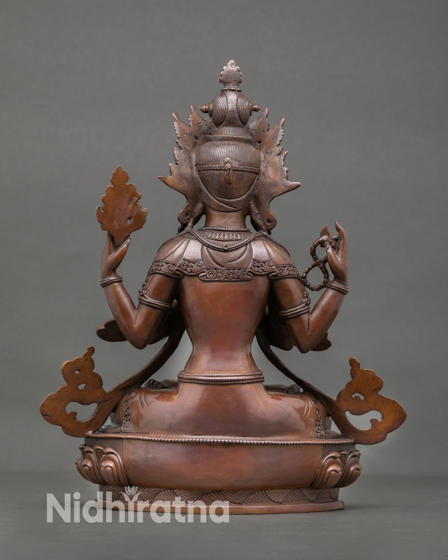 Back view of Chenrezig statue highlighting intricate metal carving, flowing design details, and authentic Nepalese lost wax copper