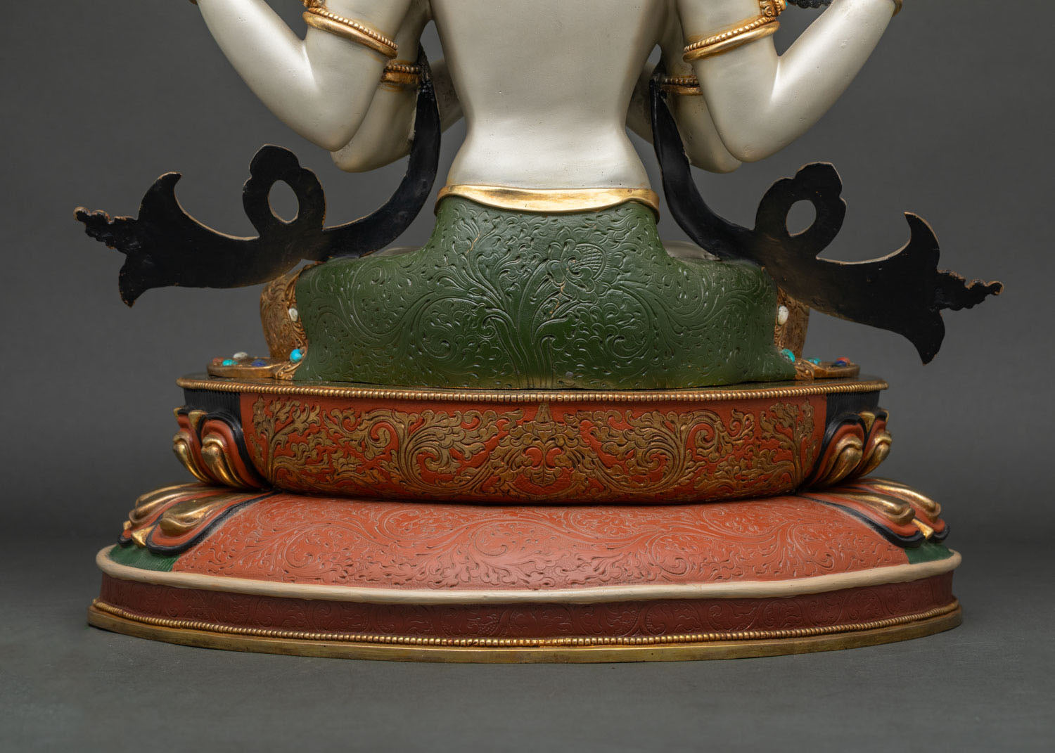 Back view of Chenrezig statue's lotus pedestal with engraved floral motifs