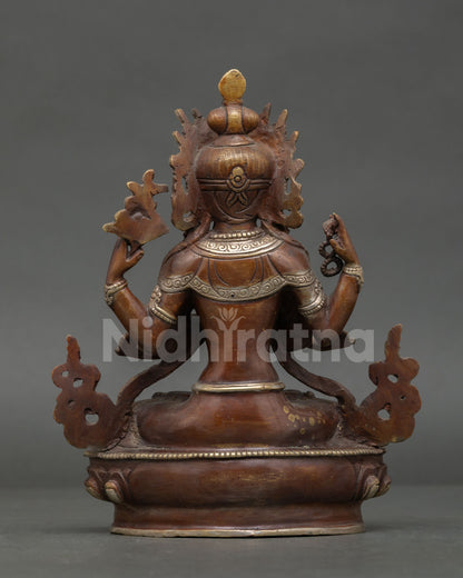 back view of chenrezig statue showing engraved lotus throne and handcrafted copper details