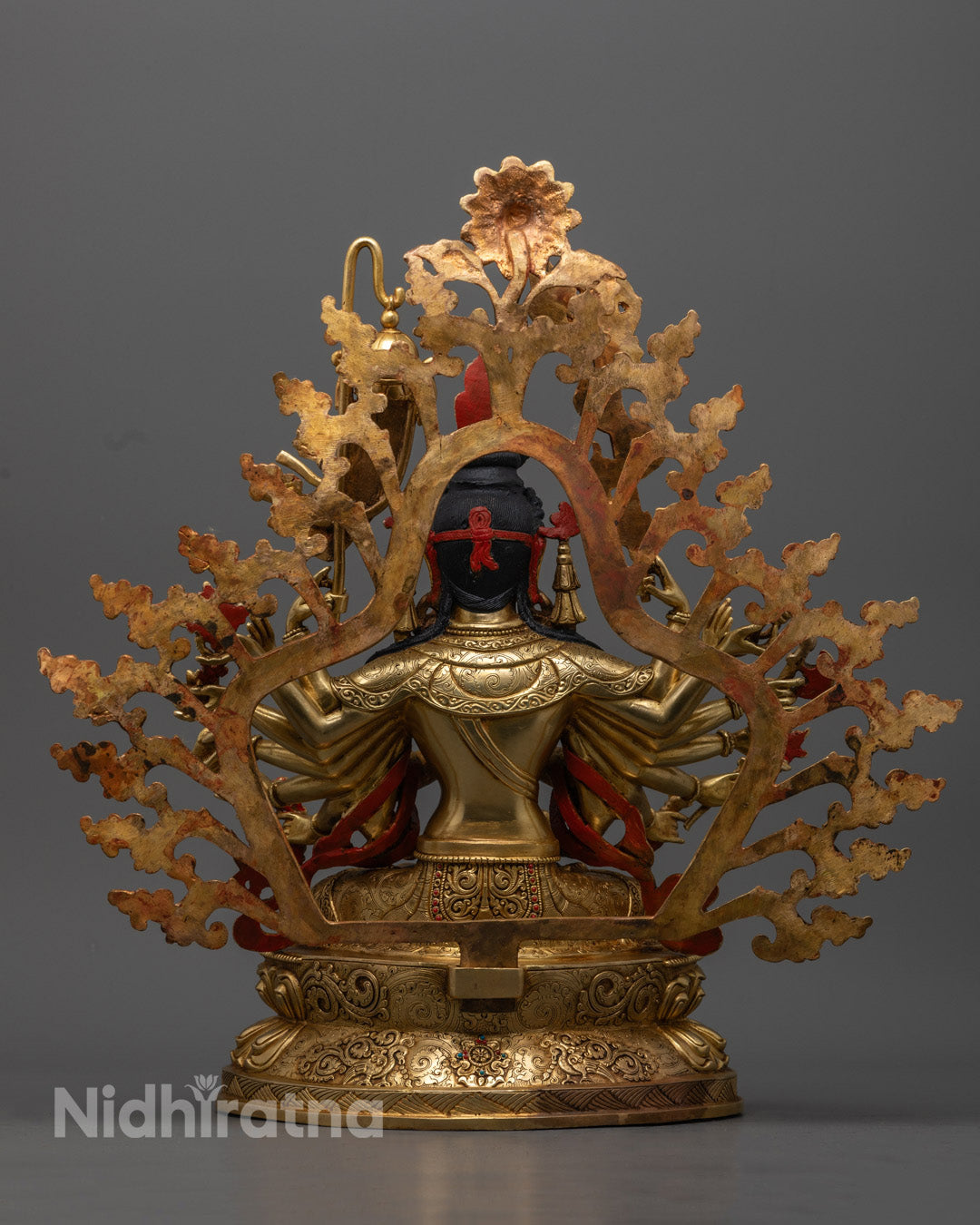 Back view of Chundi Devi statue with intricate carvings and detailed radiant halo