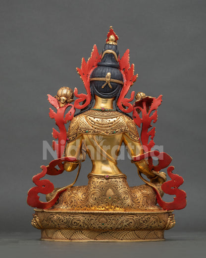 Back view of copper Green Tara statue with hand-carved gold gilded robes and red painted accents