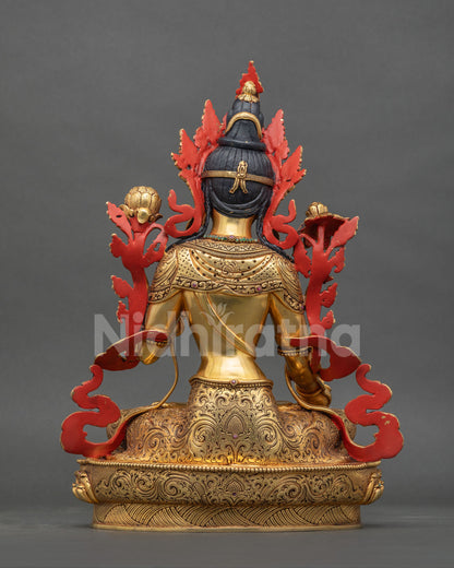 Back view of copper White Tara statue with hand-carved gold gilded robes and red painted accents