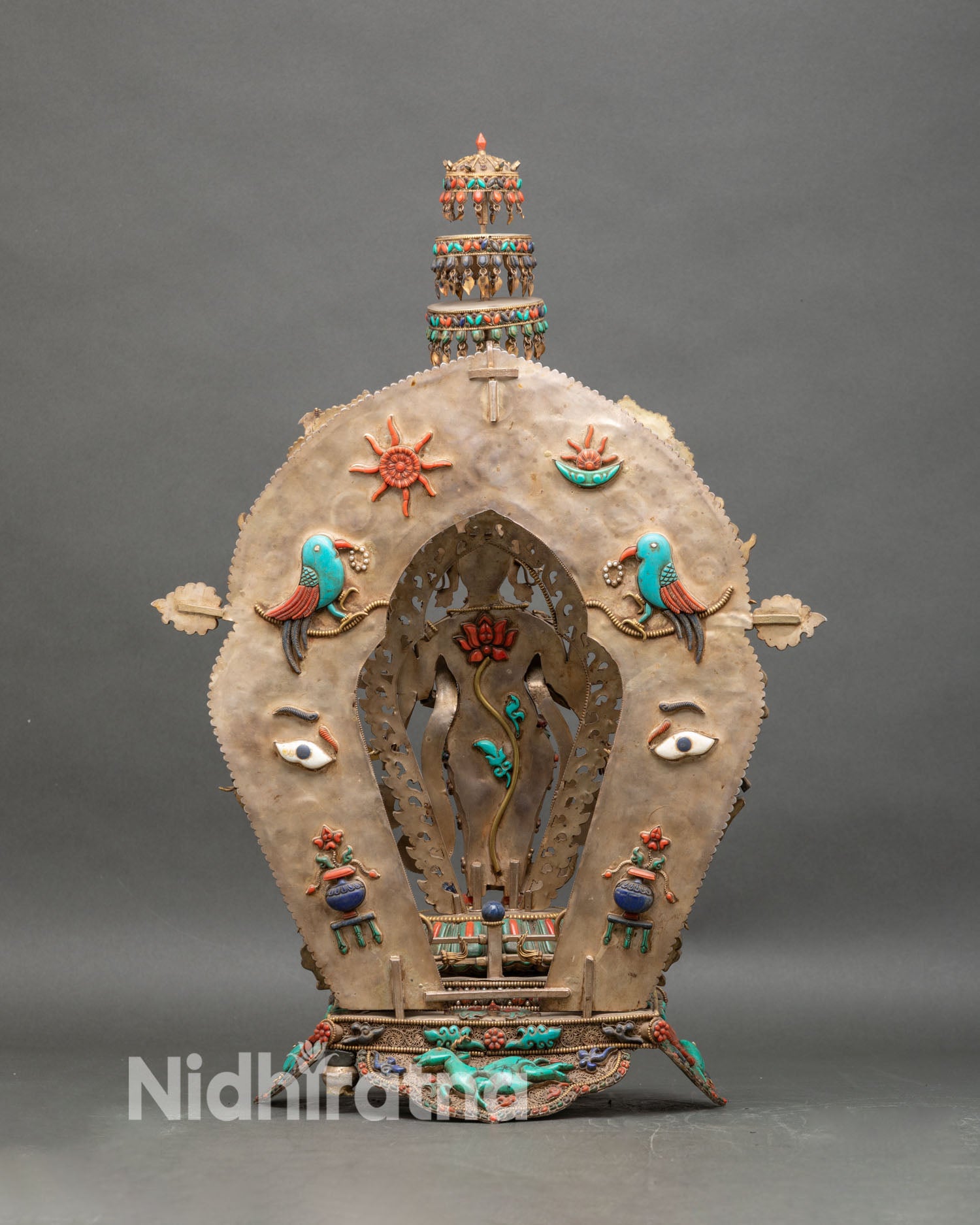 Back view of coral Avalokiteshvara statue with goald filigree halo and detailed gemstone pedestal