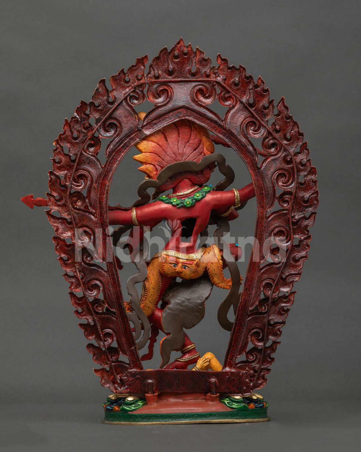 Back view of Dancing Kurukulla copper statue with ornate robes, halo and lotus base