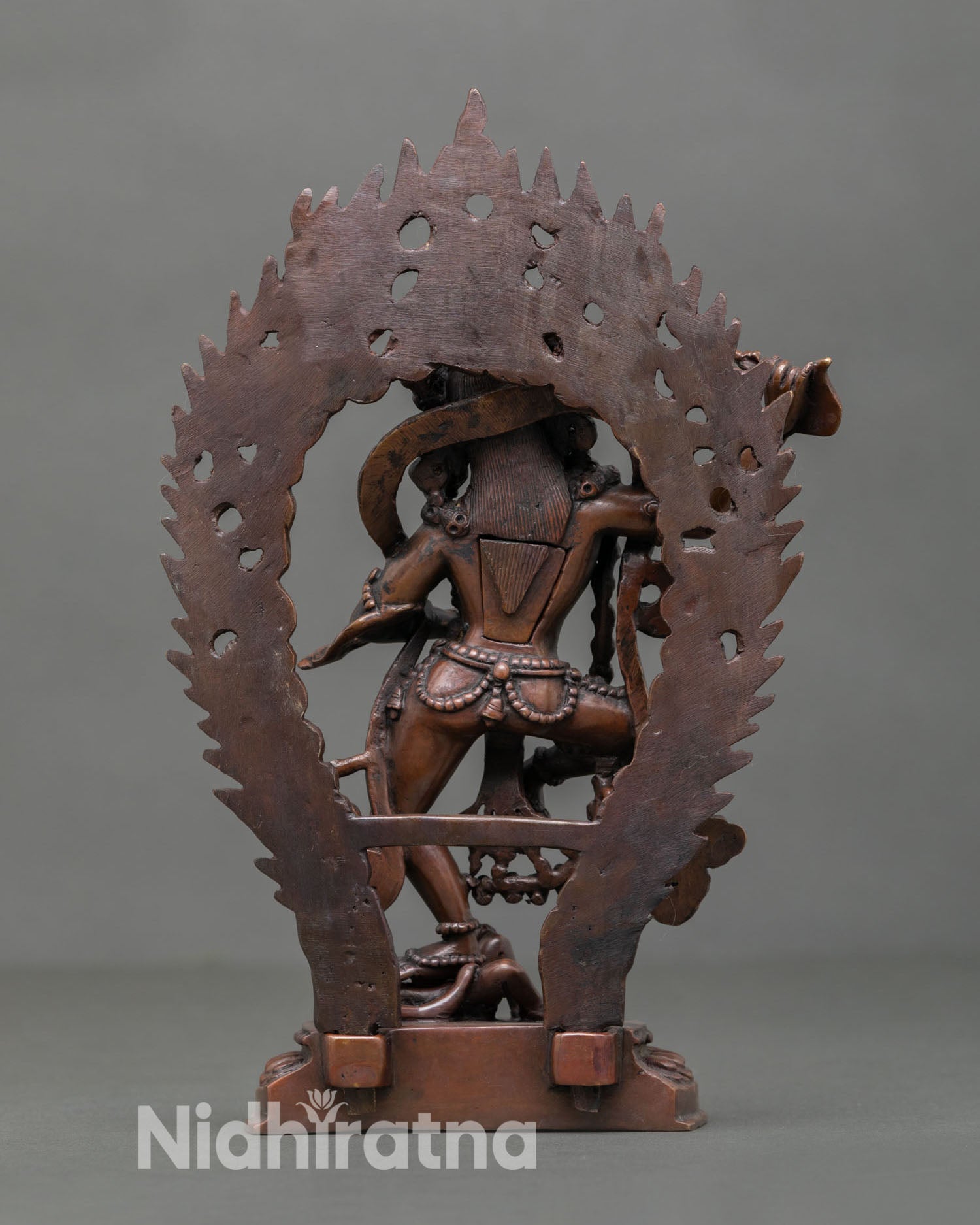 Back view of Dorje Phagmo statue showing khatvanga staff detail, handmade Nepalese Buddhist sculpture in oxidized finish for meditation altar decor.
