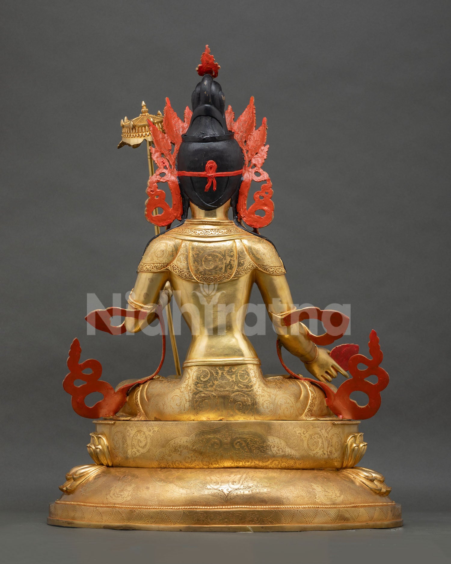 Back view of Dukar Sitatapatra statue showing gold gilded crown and lotus base, Nepal