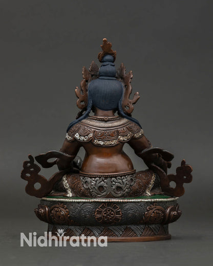 Back view of Dzambhala Buddhist statue in seated posture, ideal for meditation space home altar and spiritual prosperity decor