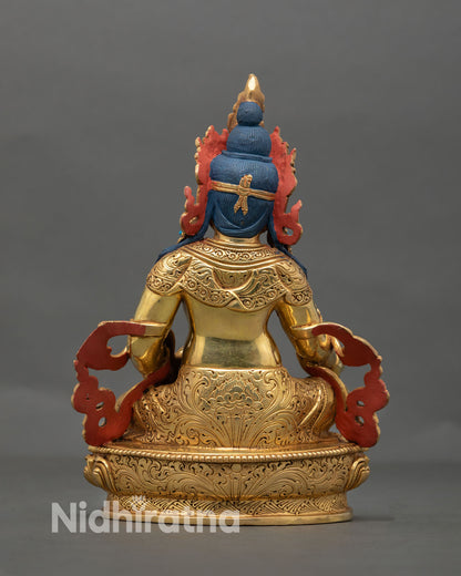 Back view of Dzambhala Buddhist wealth deity statue with finely engraved lotus pedestal and traditional Nepalese craftsmanship