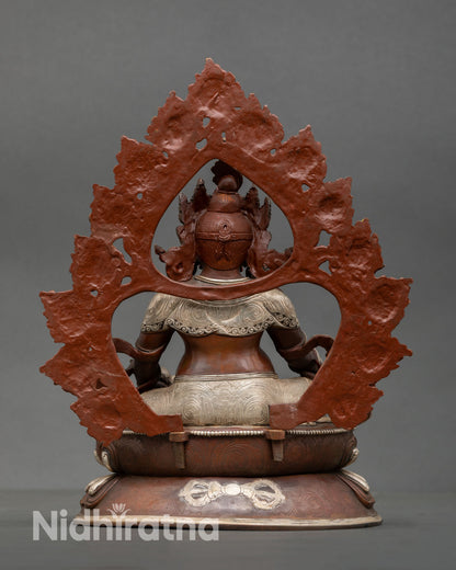 Back view of Dzambhala sculpture showing detailed craftsmanship and oxidized copper texture
