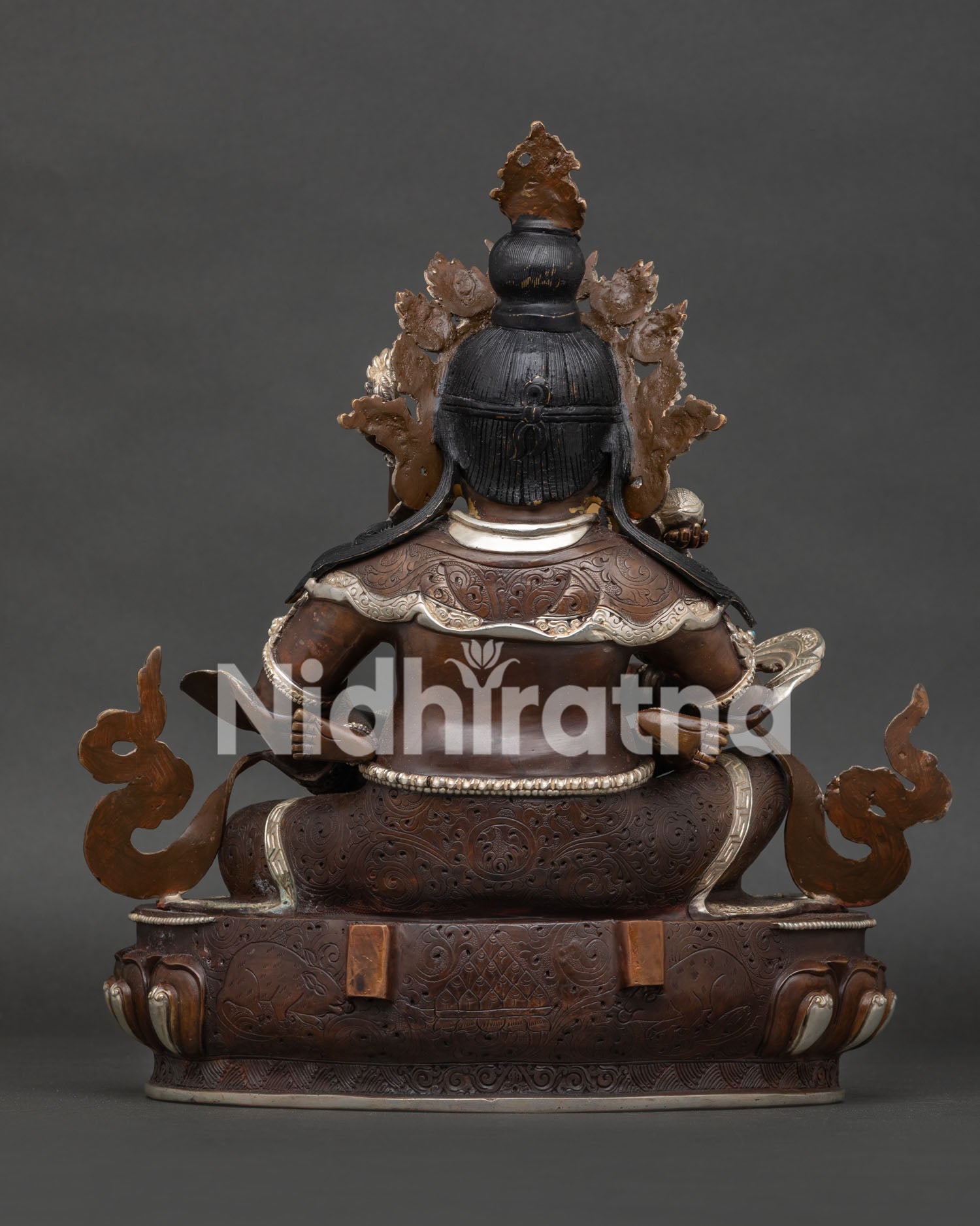 Back view of Dzambhala statue featuring intricate lost wax casting details
