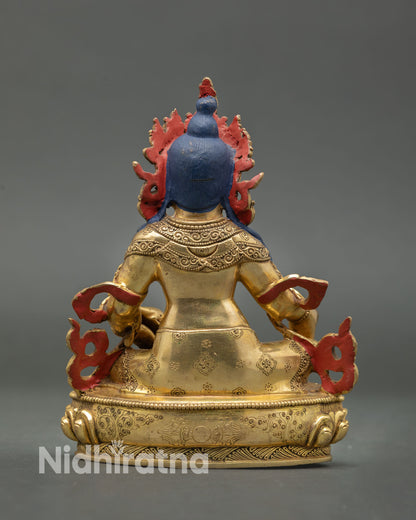 Back view of Dzambhala statue handcrafted in Nepal with intricate carving and lotus base.