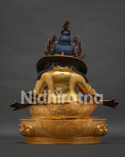 Back view of Dzambhala statue showing detailed gold gilding and traditional Nepalese craftsmanship