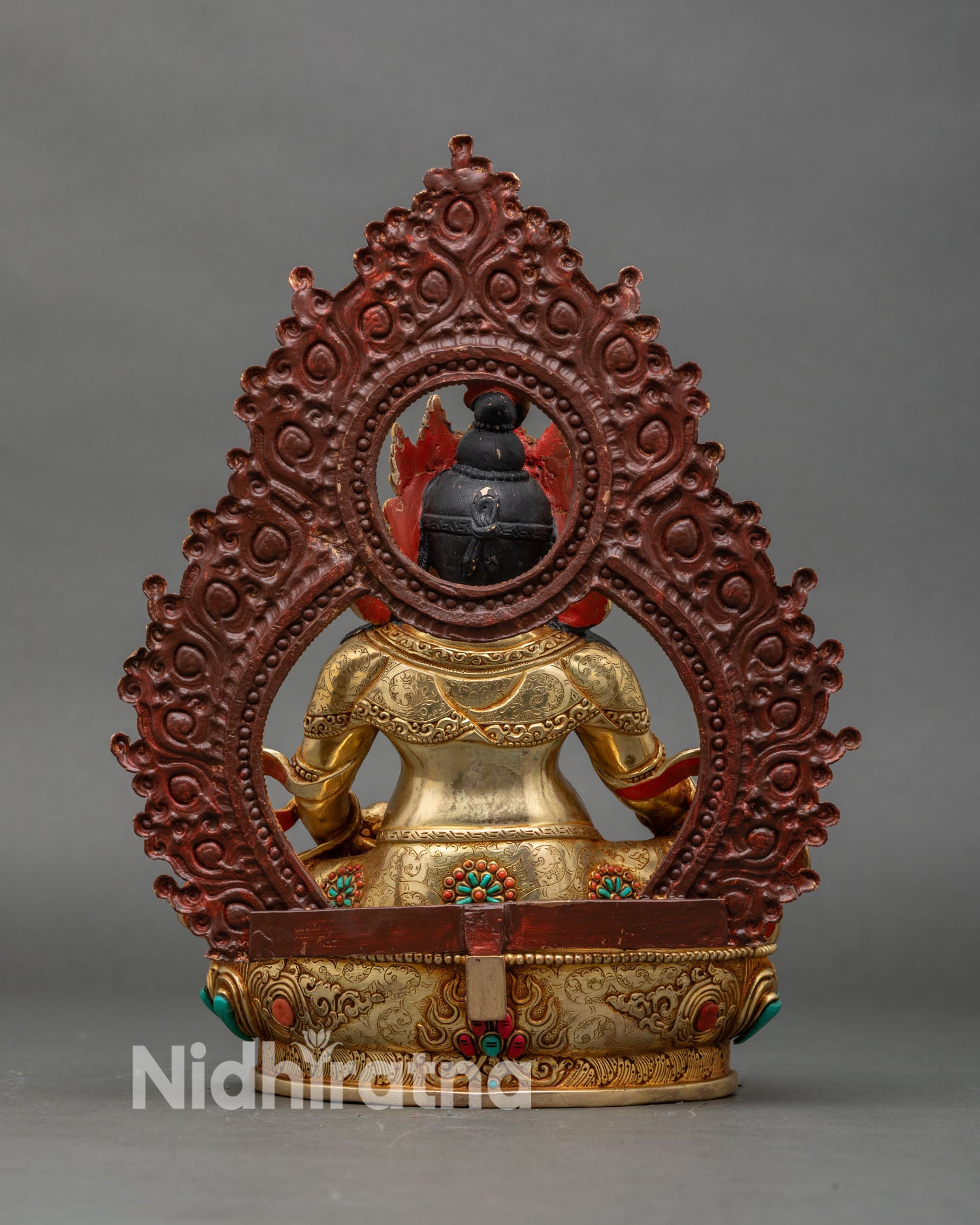Back view of Dzambhala statue showing detailed halo design and sculpted lotus pedestal
