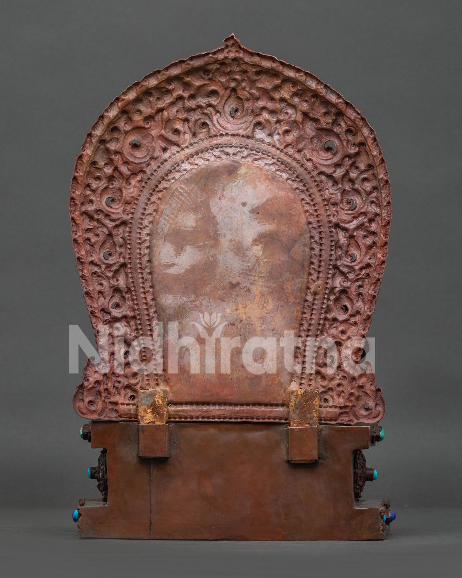 back view of Dzambhala statue showing intricate hand-carved patterns and oxidized copper finish