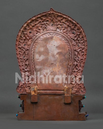 back view of Dzambhala statue showing intricate hand-carved patterns and oxidized copper finish