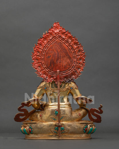 Back view of Dzambhala statue with engraved gold-gilded robe and red-painted halo