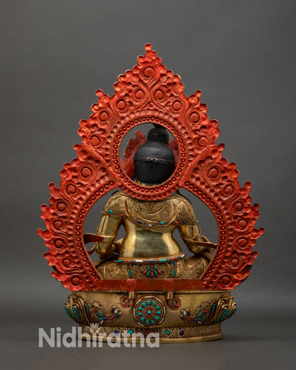 back view of dzambhala statue with engraved halo and detailed copper work