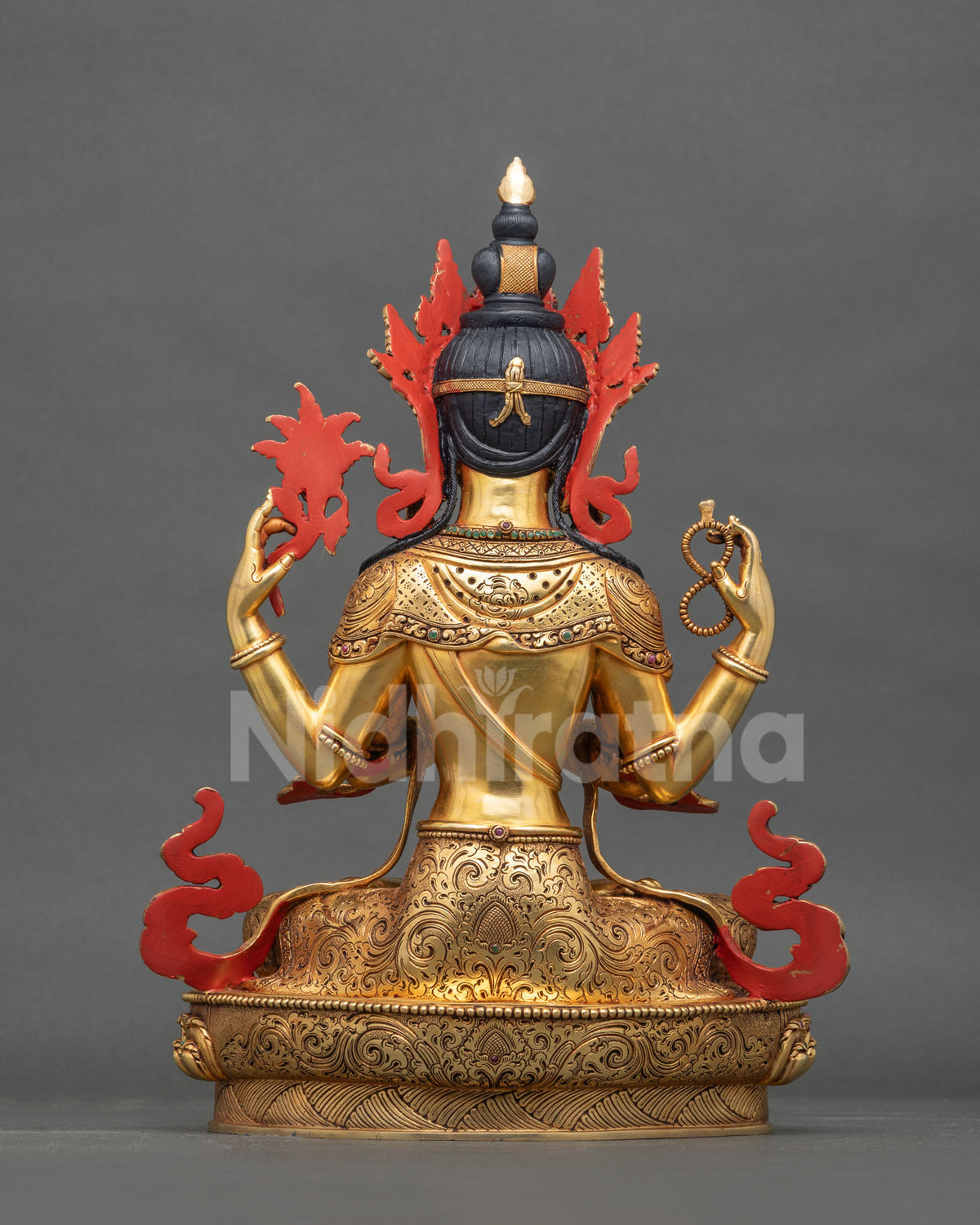 Back view of four-armed Avalokiteshvara statue showing repoussé metalwork.