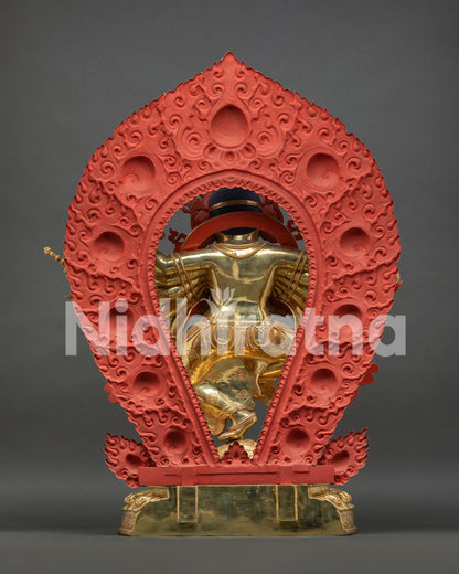 Back view of Ganesh statue showing red hand-carved flaming halo details