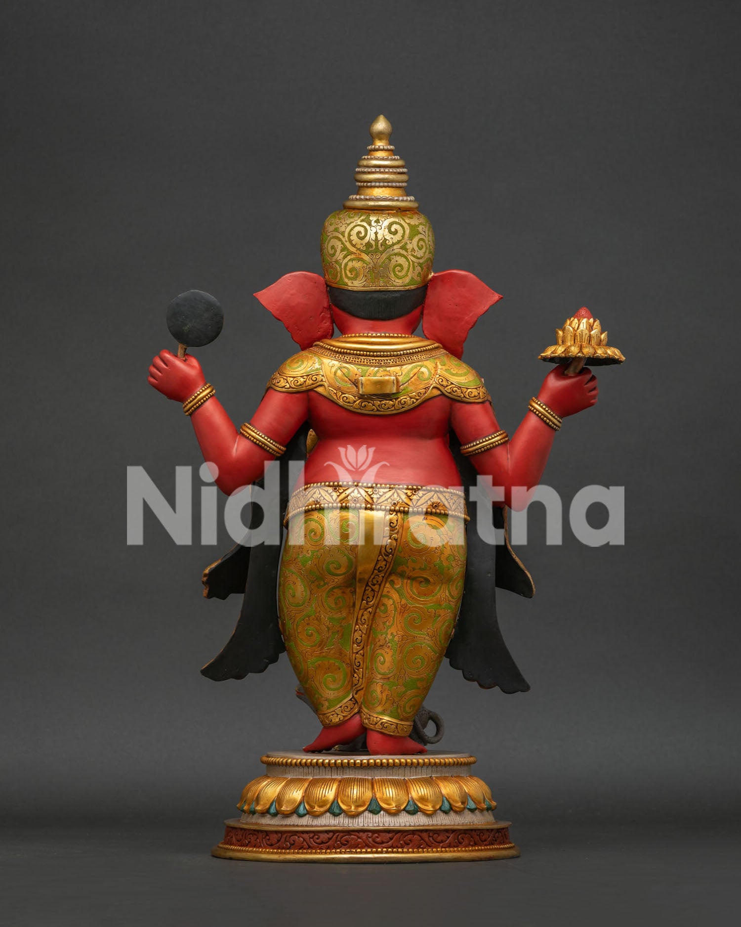 Back view of Ganesha statue showing golden halo and flowing robe details