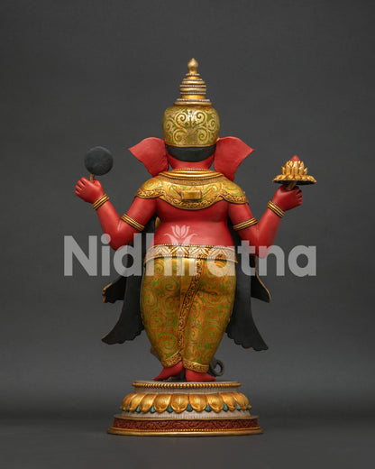 Back view of Ganesha statue showing golden halo and flowing robe details
