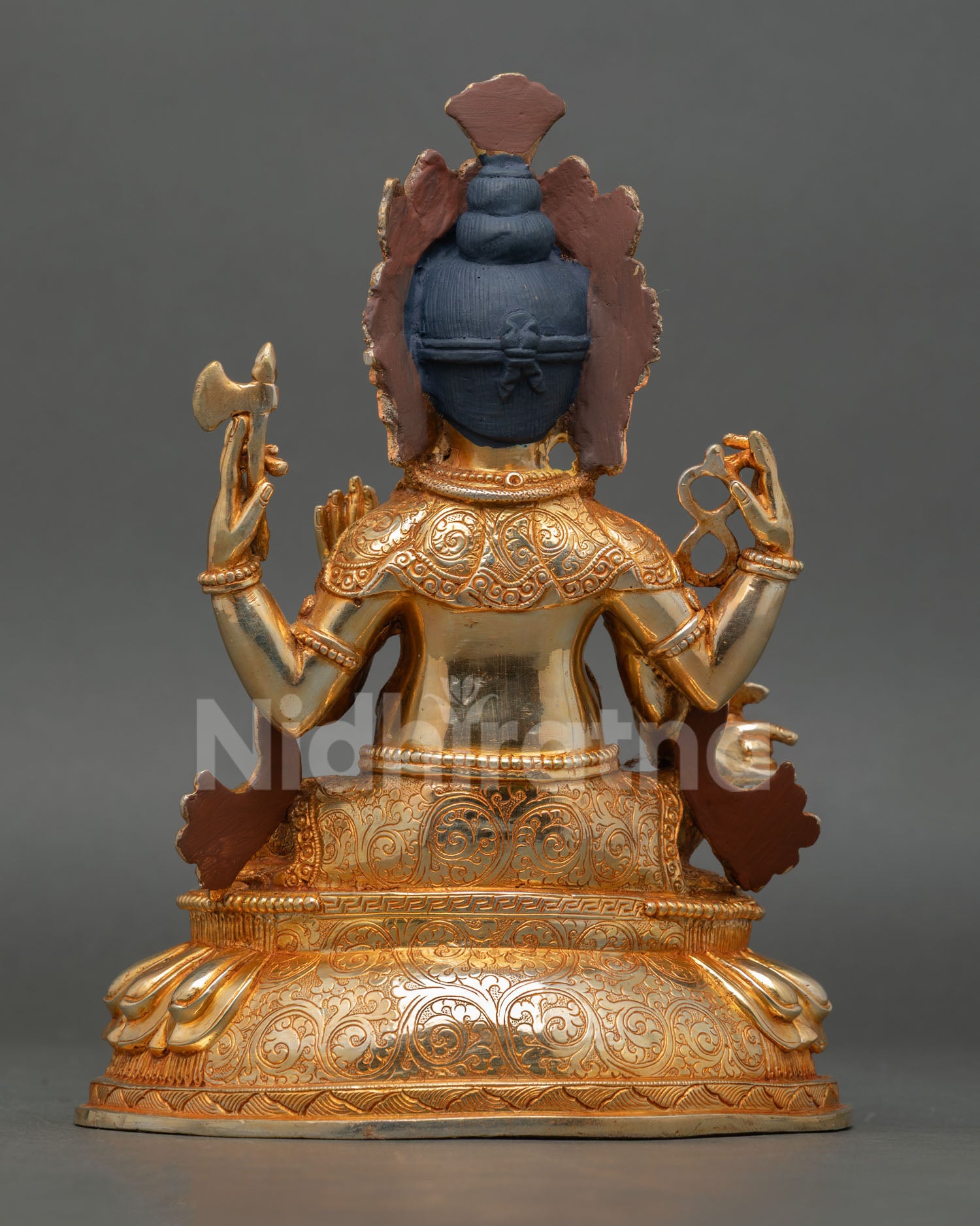 back view of ganesha statue with detailed crown and handcrafted copper finish