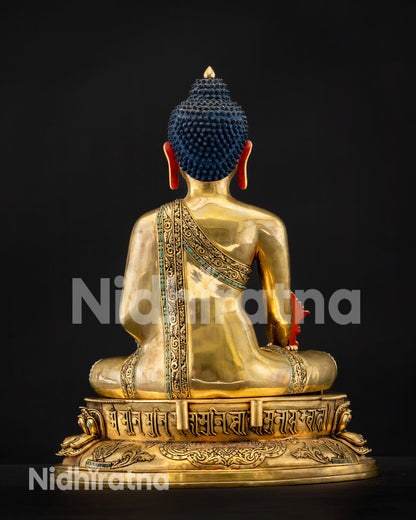 Back view of gilded Bhaisajyaguru with blue ushnisha and Tibetan mantra engraved on lotus pedestal base