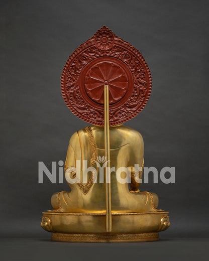 Back view of gold gilded Buddha statue featuring rear support structure and carved halo base.