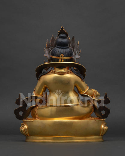 Back view of gold gilded copper Dzambhala statue showing crown and robe detail