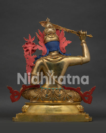 Back view of gold-gilded copper Manjushri statue, handmade Nepal Buddhist art