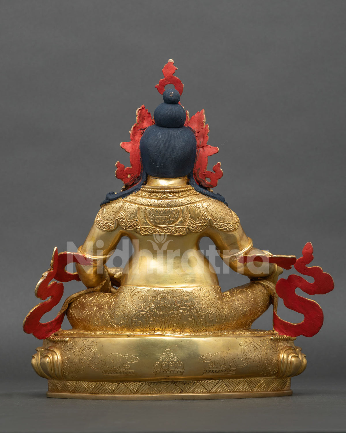 Back view of gold gilded Dzambhala copper statue with flowing scarves and lotus throne base