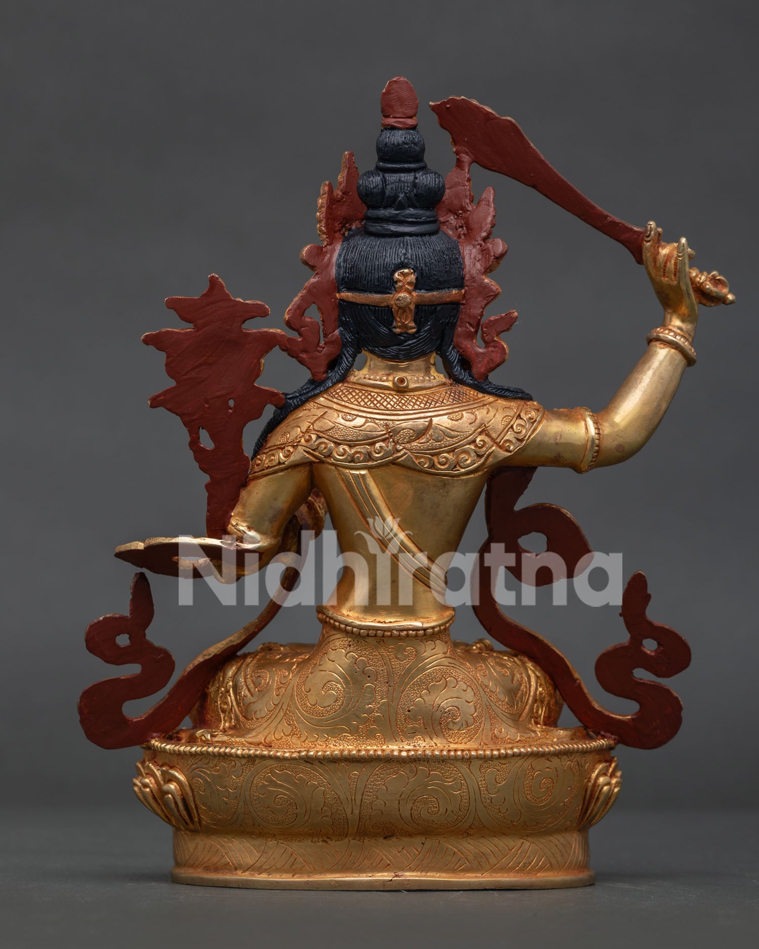 Back view of gold gilded Manjushri statue with intricate Himalayan Buddhist craftsmanship