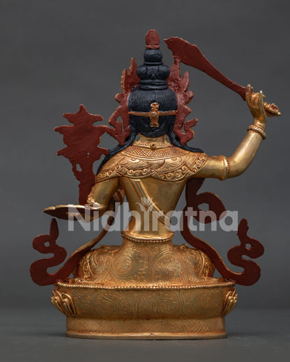 Back view of gold gilded Manjushri statue with intricate Himalayan Buddhist craftsmanship