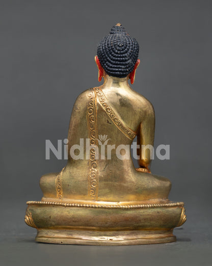 Back view of gold gilded Shakyamuni Buddha statue showcasing Nepalese metalwork and Buddhist sculpture details.