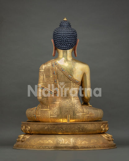 back view of gold gilded shakyamuni buddha statue with traditional newari craftsmanship