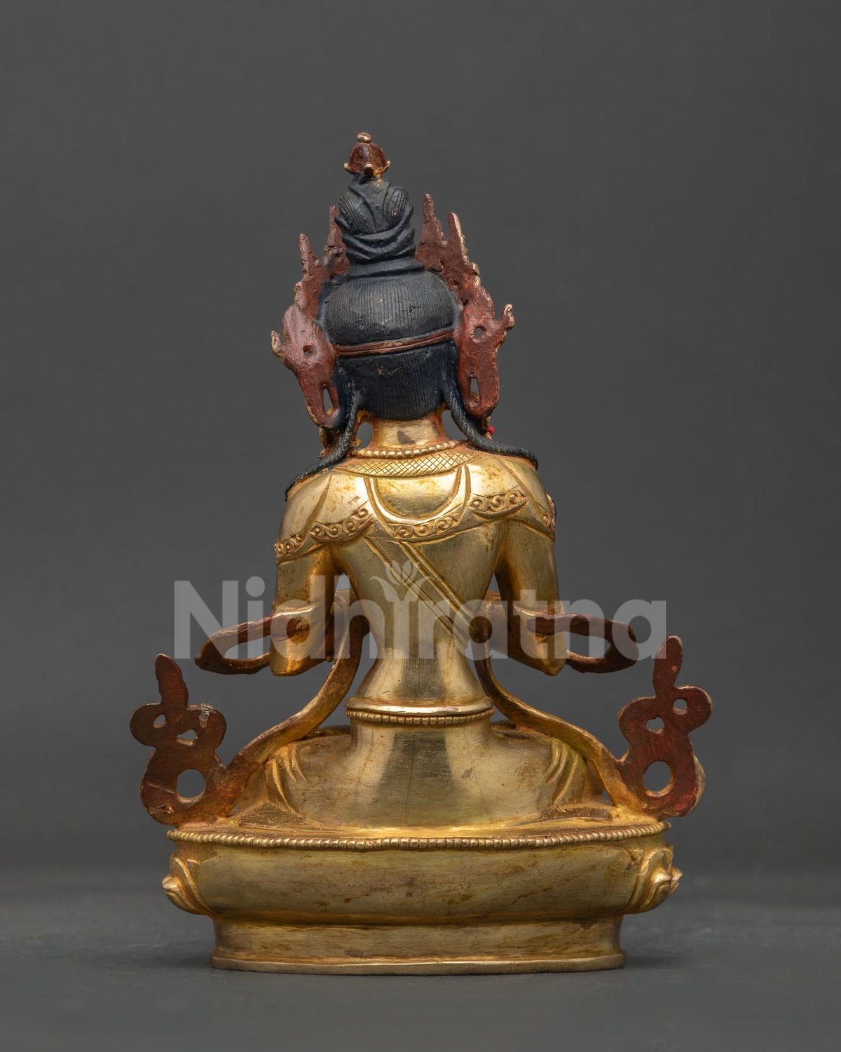 Back view of gold gilded vajradhara statue showcasing detailed robes crown and hand carved lotus pedestal.