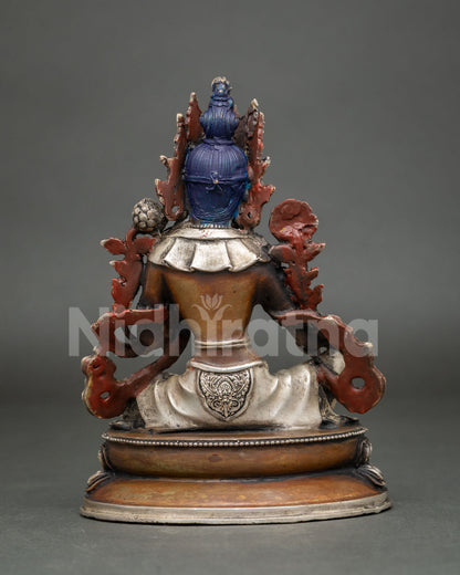 Back view of Green Tara copper statue with ornate backrest and silver-toned base