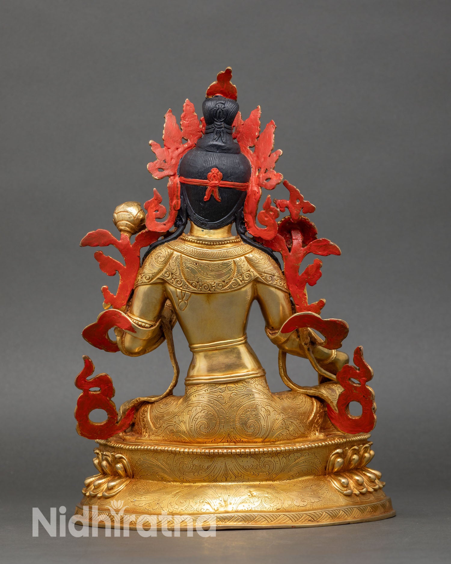 back view of green tara sgrol ljang statue showing engraved lotus and throne details