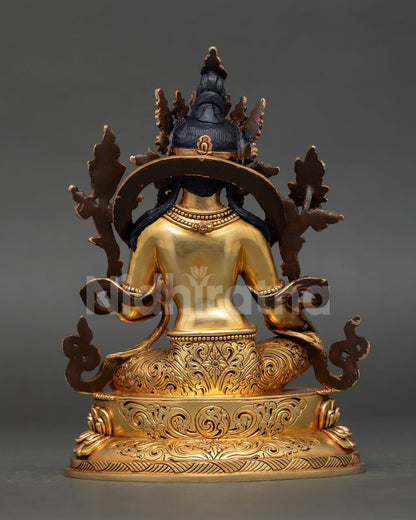 back view of green tara statue highlighting engraved robe details, lotus throne base and artisan workmanship