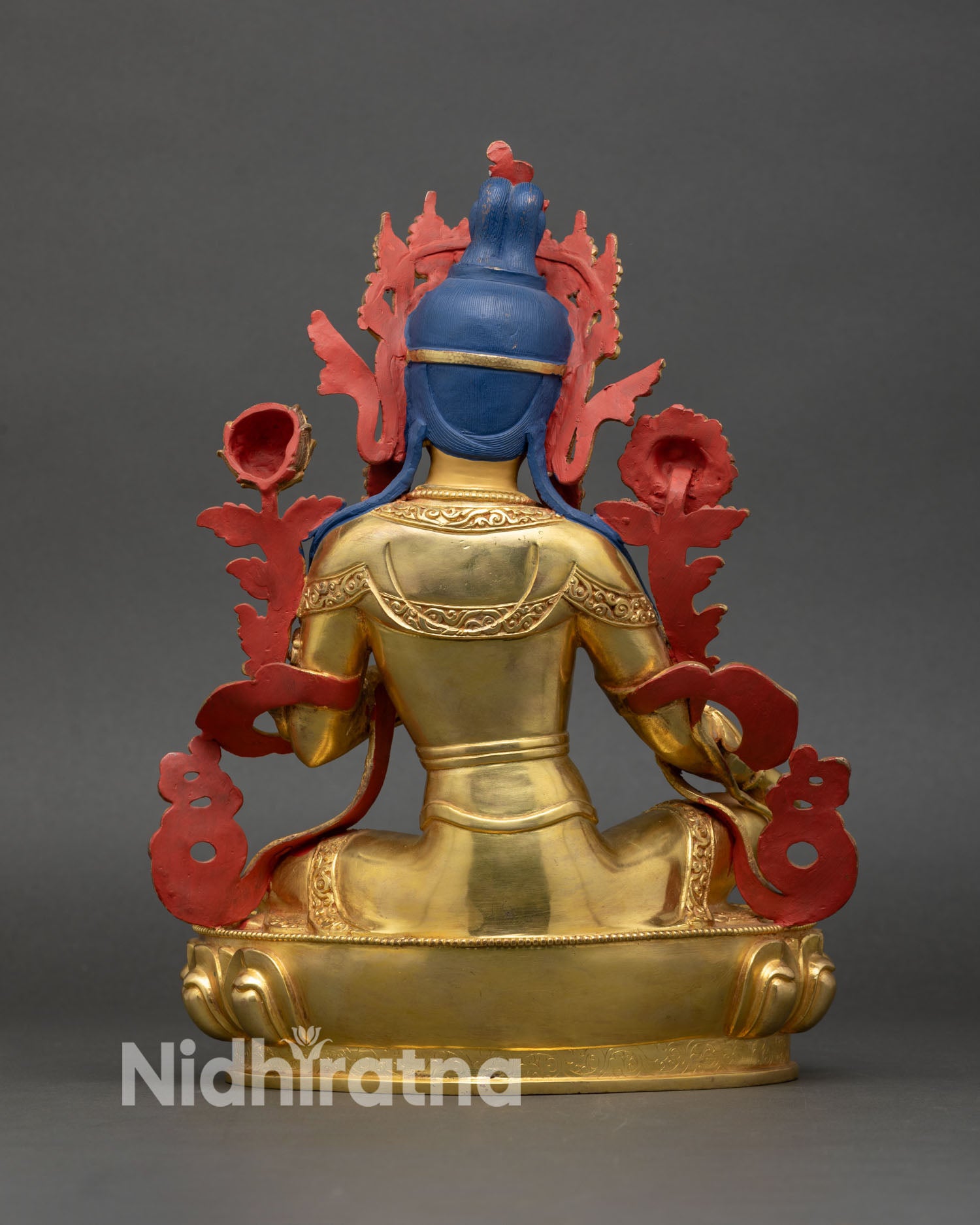 back view of green tara statue, lotus pedestal with hand-carved nepalese iconography
