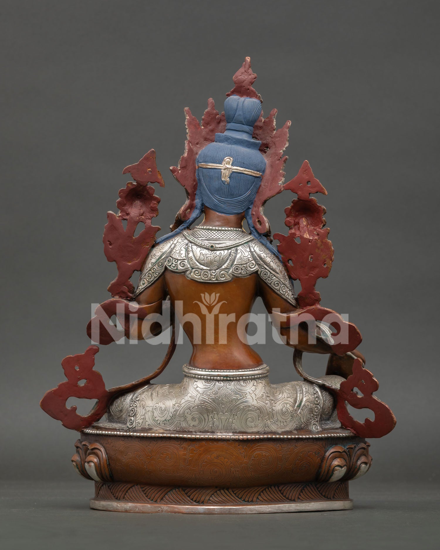 Back view of Green Tara statue, revealing detailed copper craftsmanship, oxidized finish and sacred Buddhist artwork