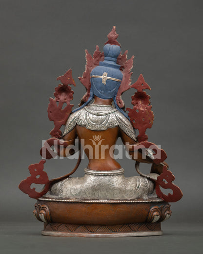 Back view of Green Tara statue, revealing detailed copper craftsmanship, oxidized finish and sacred Buddhist artwork