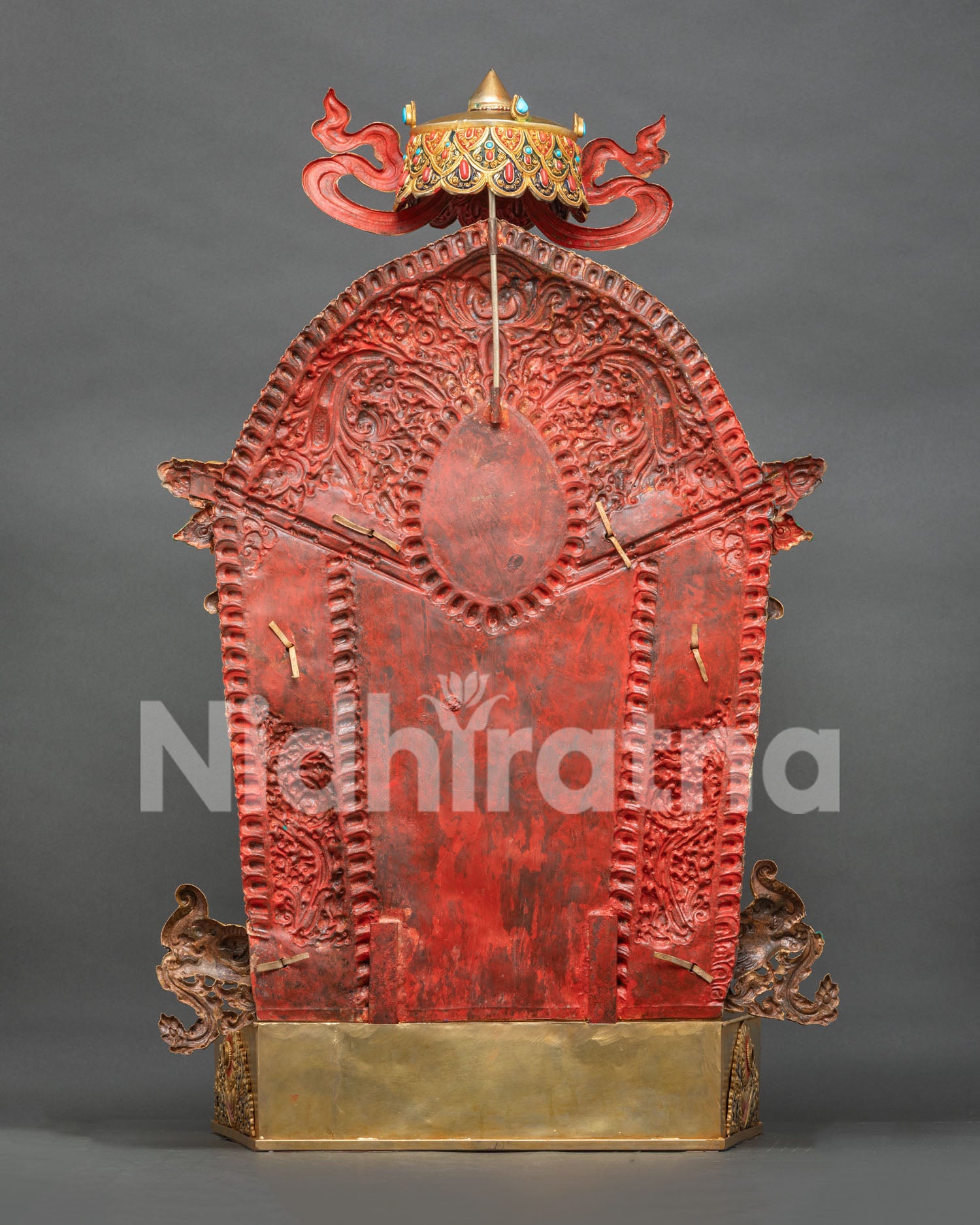 Back view of Green Tara statue showing blue topknot, painted robes, and gold-gilded throne base