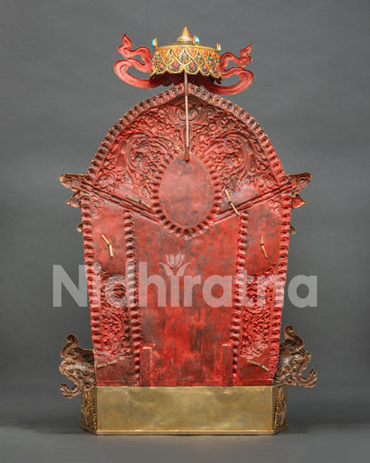 Back view of Green Tara statue showing blue topknot, painted robes, and gold-gilded throne base