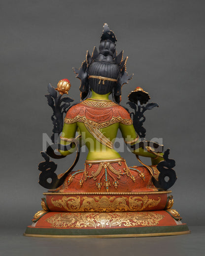 Back view of Green Tara statue showing carved copper repoussé garment and radiant gold gilded finish details