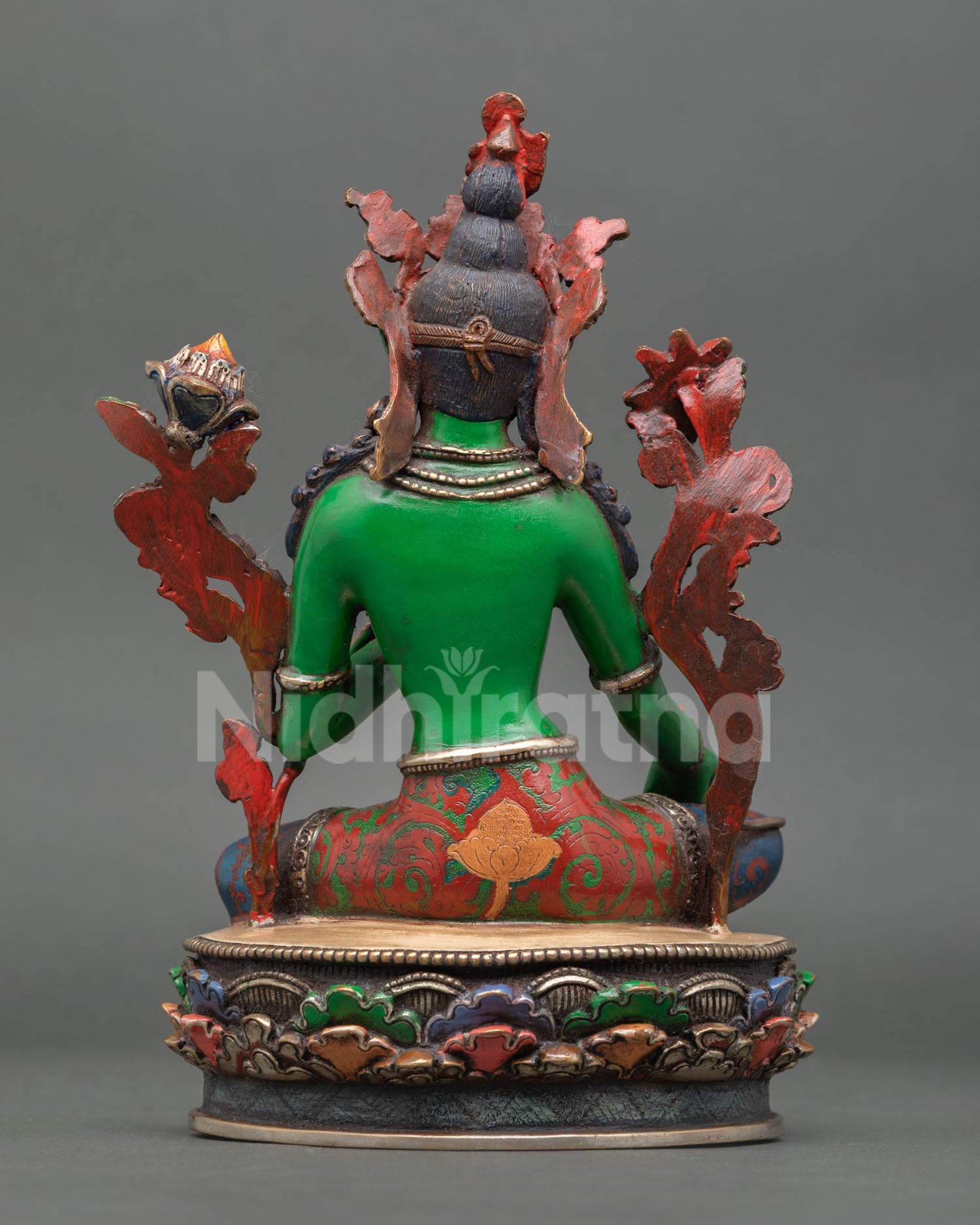 back view of green tara statue showing detailed copper craftsmanship and painting