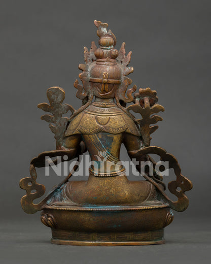 back view of green tara statue showing detailed lotus pedestal and traditional handcrafted copper artwork