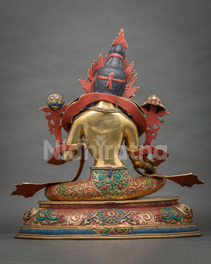 Back view of Green Tara statue showing gold-gilded body, red scarves and engraved lotus base