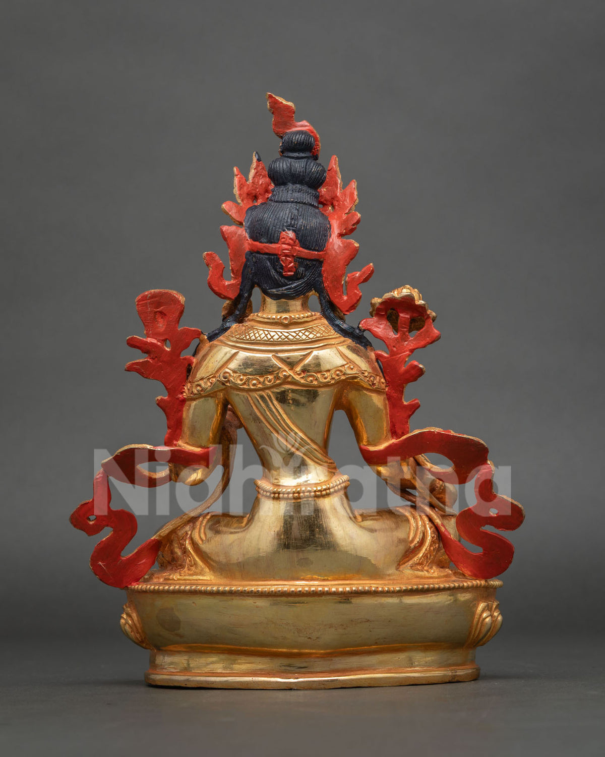 Back view of Green Tara statue showing painted red halo, gilded back and lotus pedestal